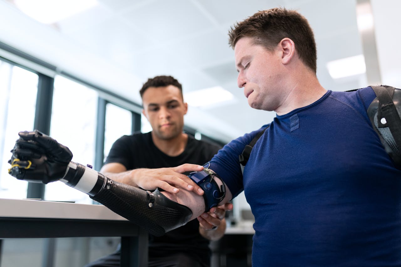 engineer fitting prosthetic arm 3912950
